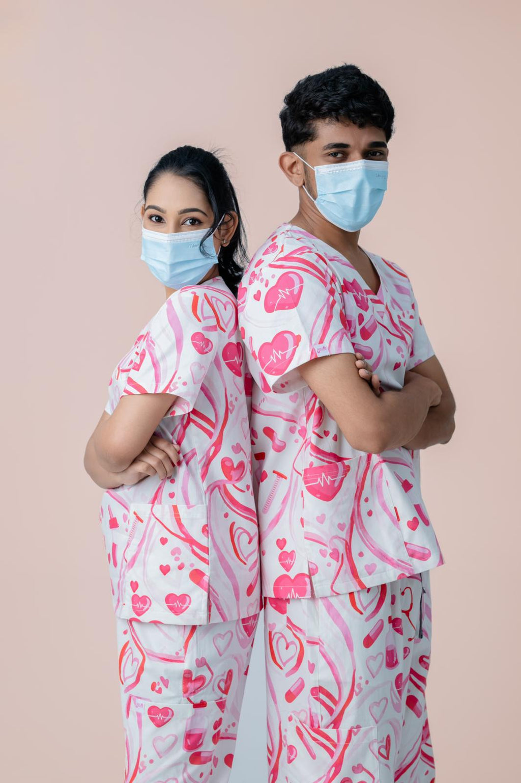 Matching pink heart print medical scrub tops for healthcare workers