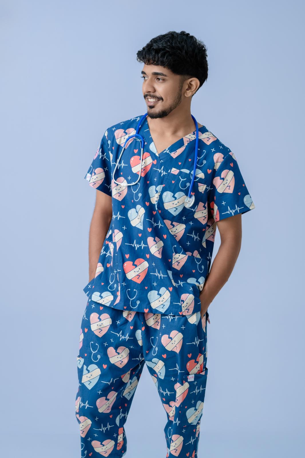 Female healthcare professional wearing navy blue heart print scrub top