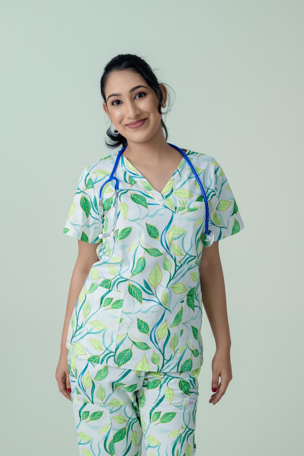 Female healthcare worker wearing green botanical print scrub top