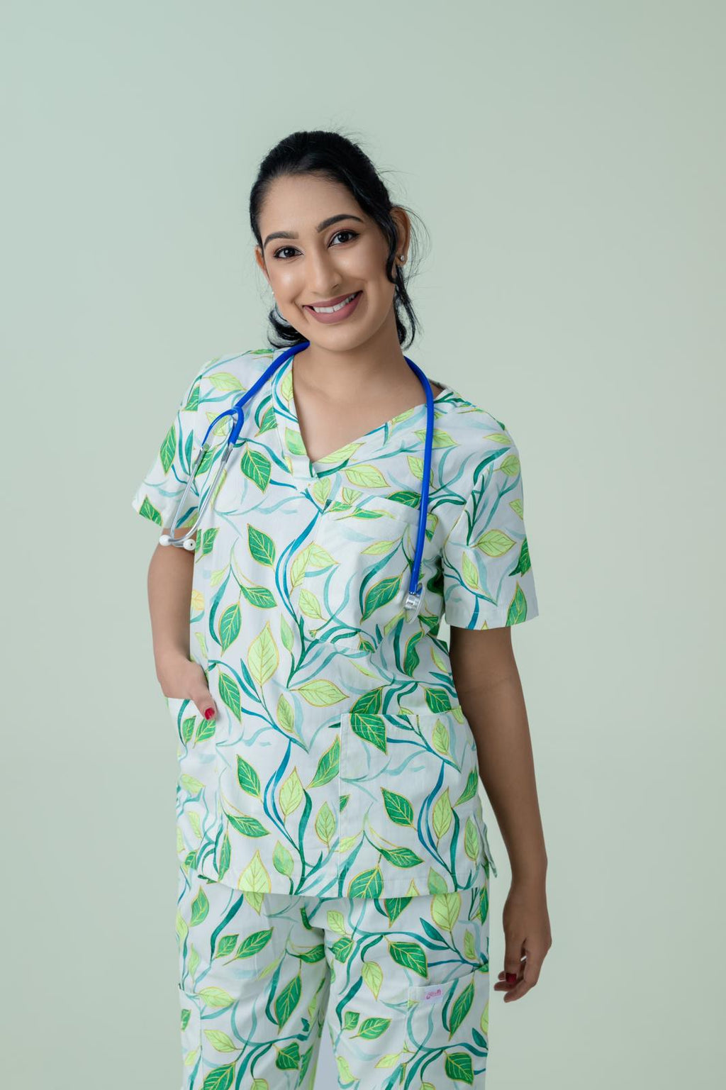 Healthcare worker wearing breathable botanical print scrub uniform