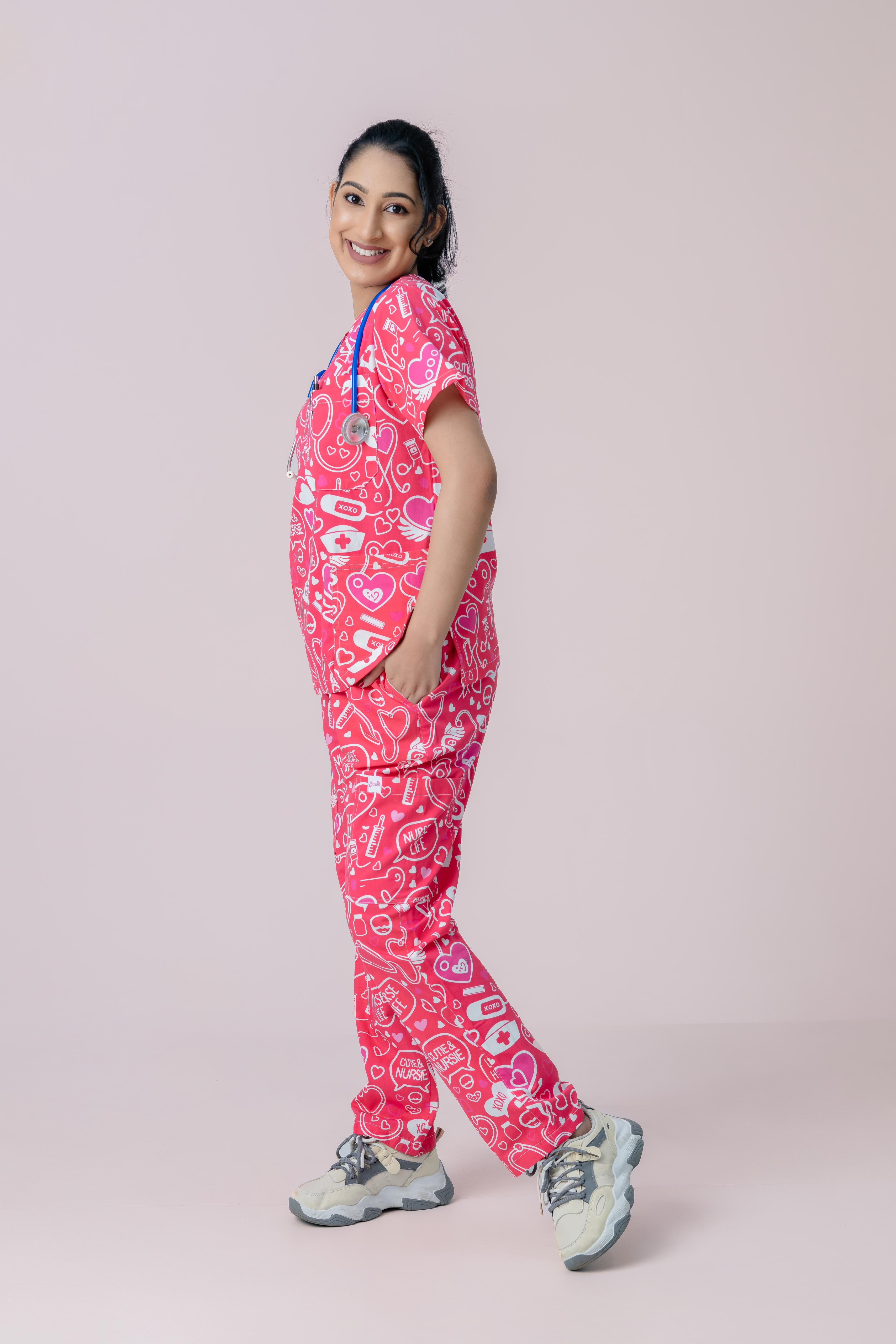 Side view of female nurse wearing pink medical scrub set