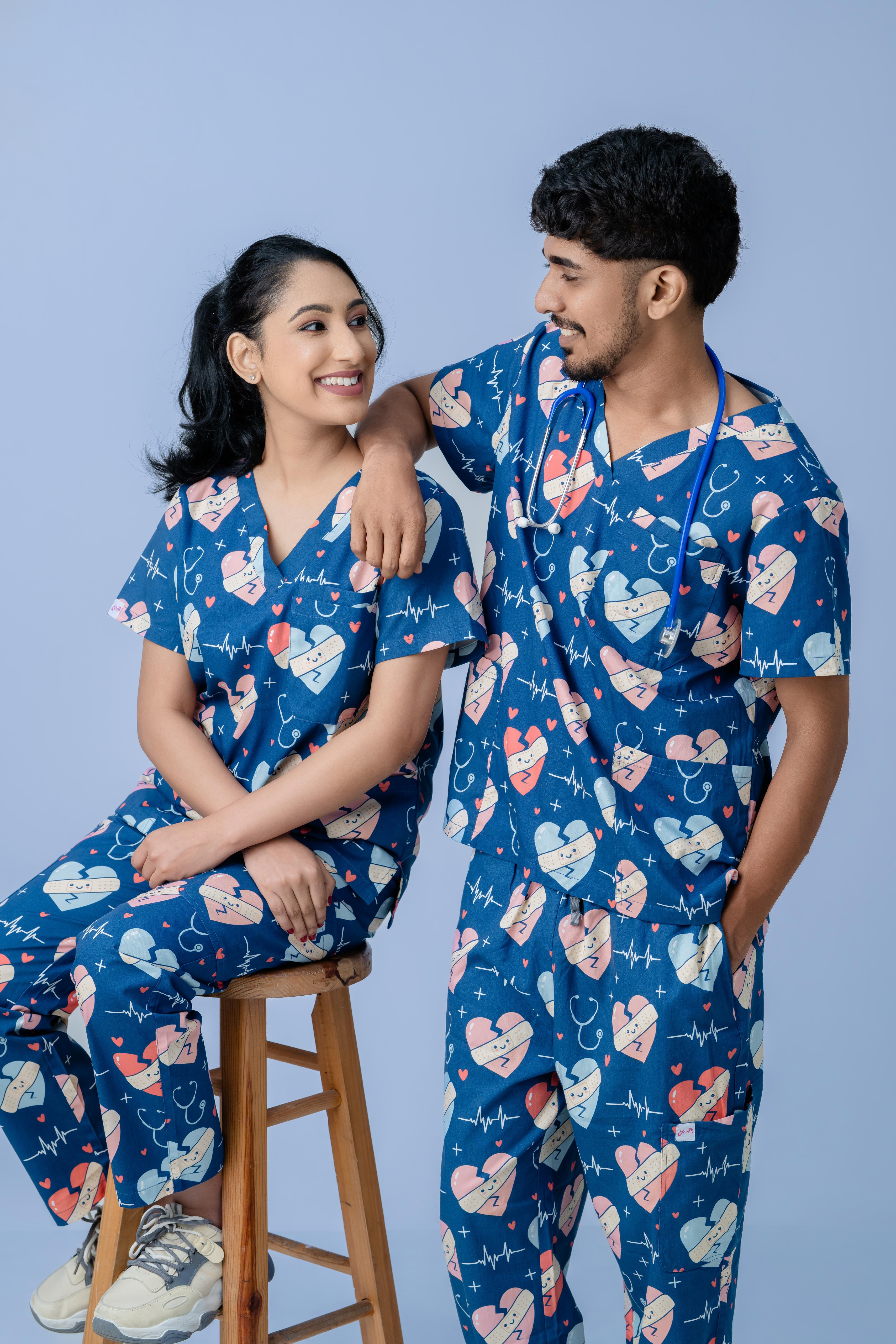 Male and female medical professionals wearing matching navy blue scrub sets