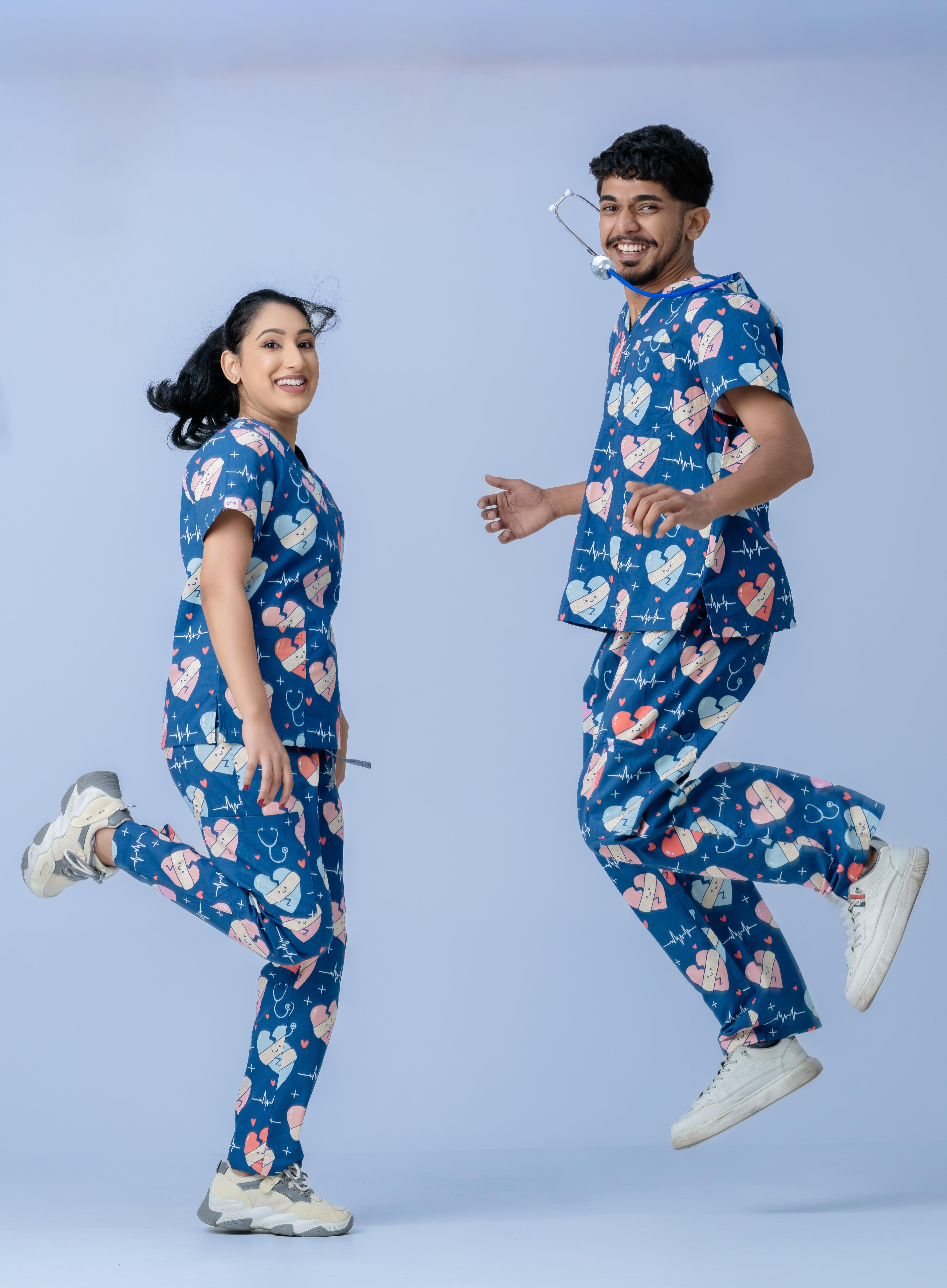Nurses wearing stylish navy blue scrub uniforms with heart print design